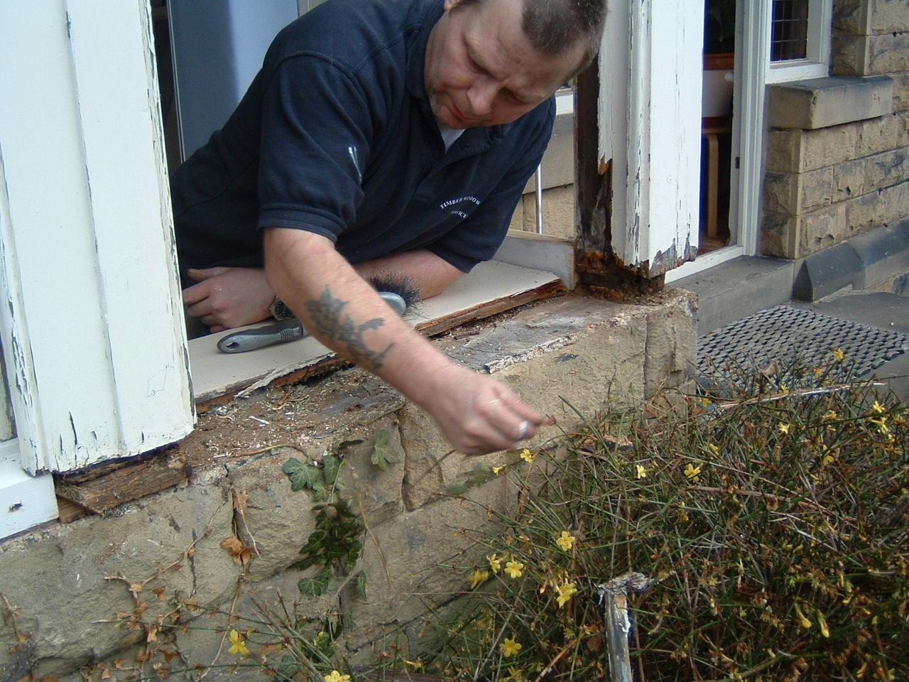 Tradesperson working on casement window repair