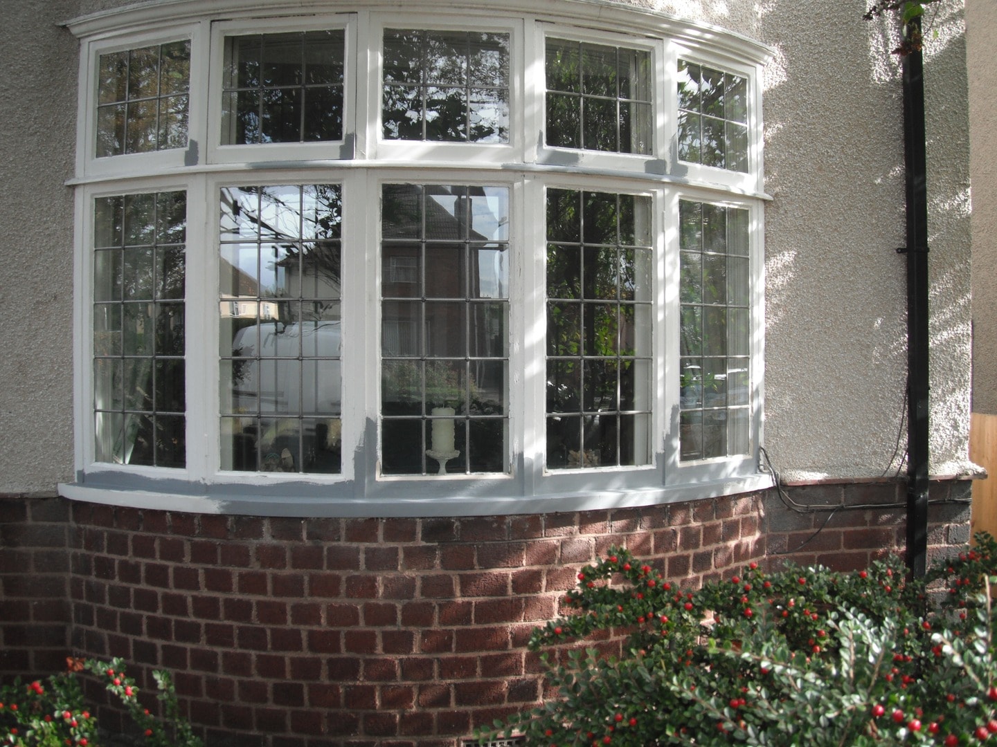 Restored casement bay window with fresh white paintwork
